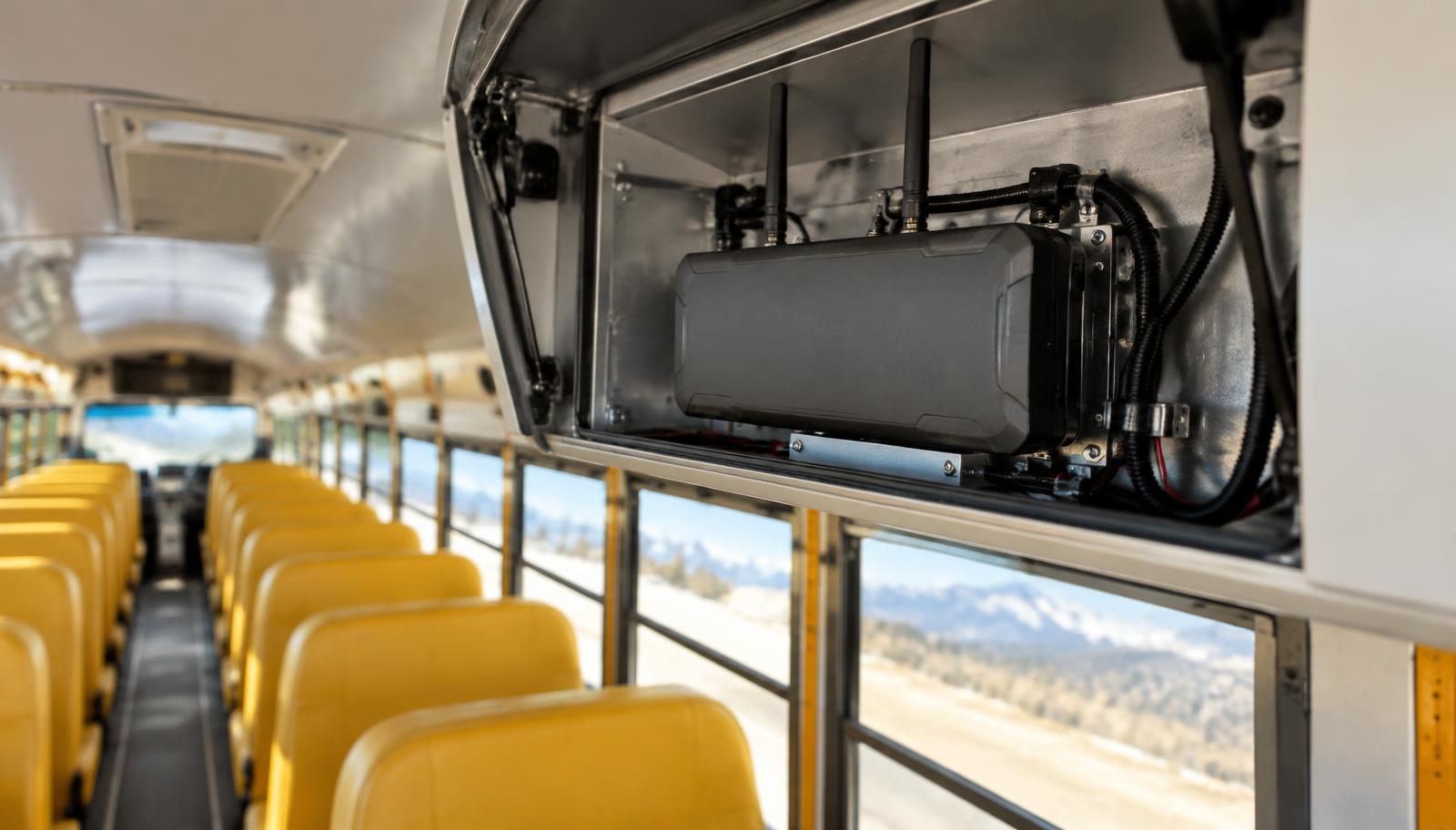 Cellular router and antenna cabling inside a school bus overhead compartment
